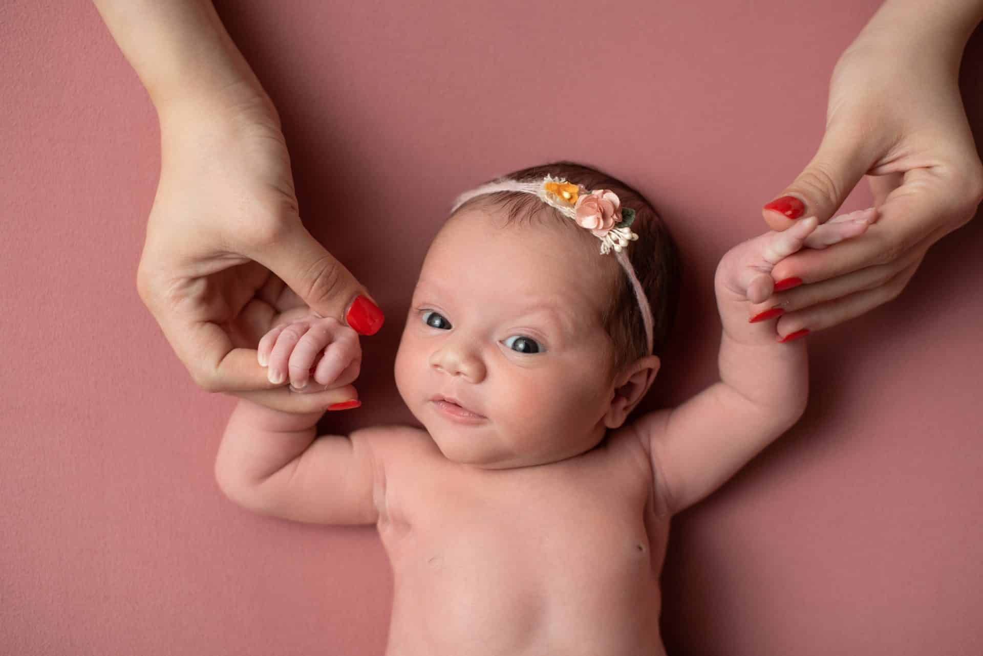 Precious newborn baby holding adult fingers, perfect for a newborn photo session Mississauga, capturing early family moments.