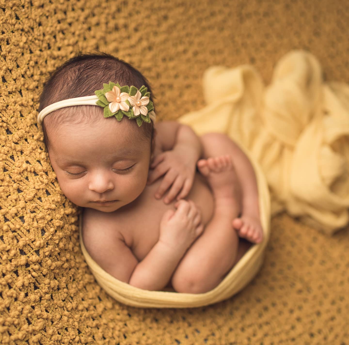 Newborn baby girl sleeping on the yellow blanket, Toronto