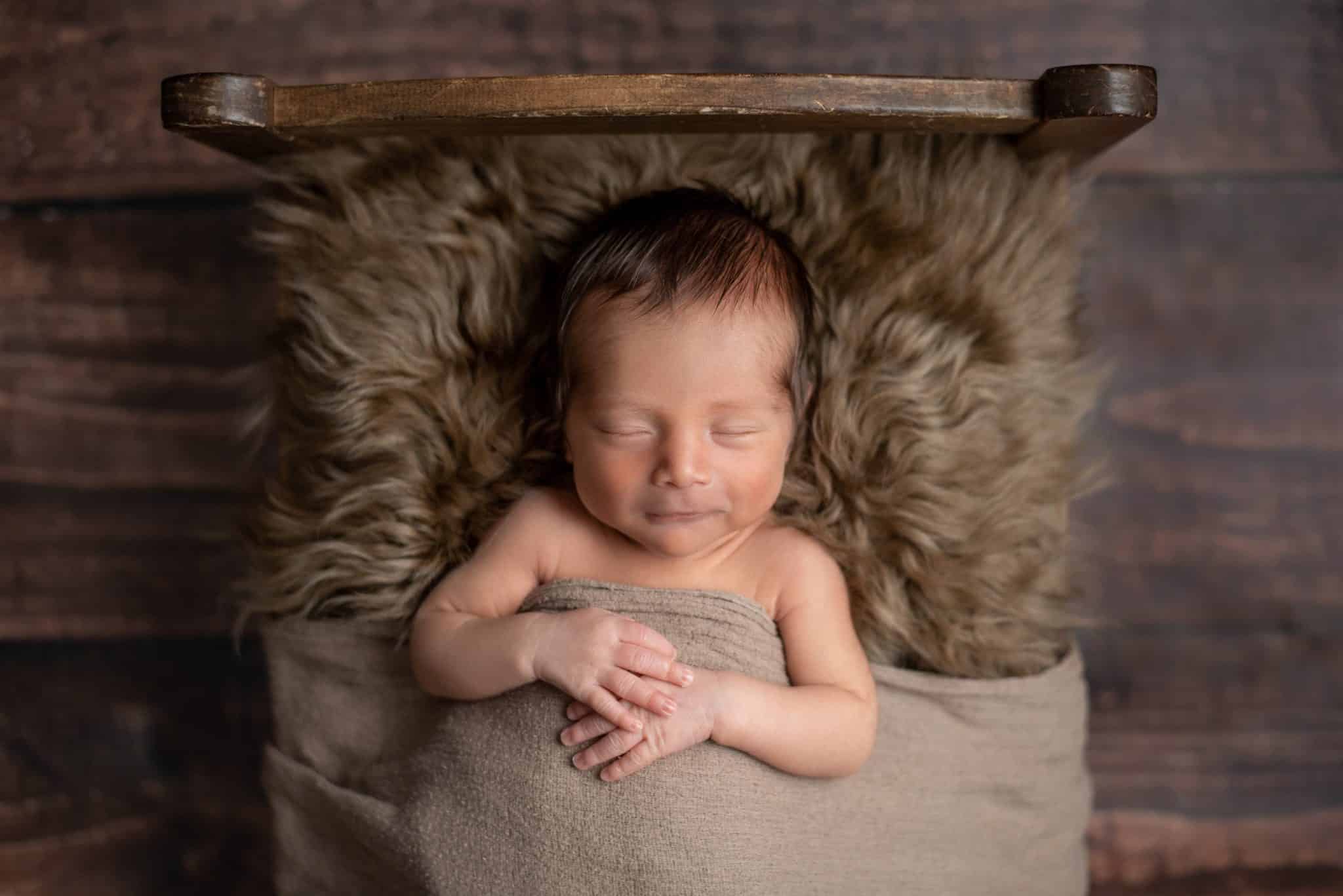 Baby in the crib during in-home newborn photo session in Mississauga